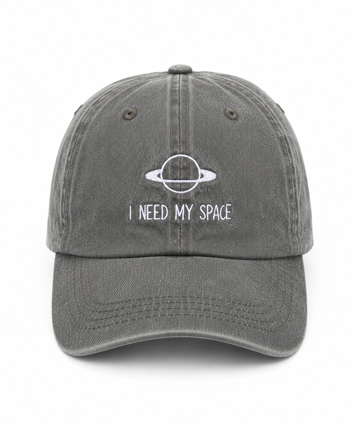 A washed dark gray baseball cap featuring a white embroidered graphic of a ringed planet and the text 'I NEED MY SPACE' on the front, set against a plain white background.
